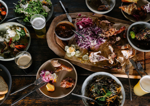Beerfarm smoked meats board on table being shared 