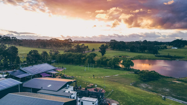 A drone photo over sunset of the Beerfarm grounds and green fields over Metricup, WA